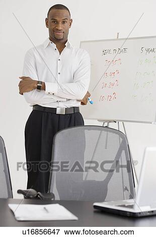 Stock Photo - Portrait of businessman next to whiteboard. Fotosearch