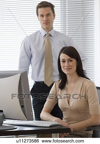 Portrait of businesspeople next to computer View Large Photo Image Stock Photograph - Portrait of businesspeople next to computer. Fotosearch