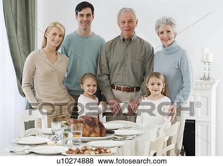 Portrait of family at Thanksgiving table View Large Photo Image Stock Photo - Portrait of family at Thanksgiving table. Fotosearch