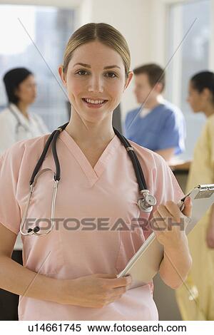 Portrait of female doctor holding medical chart View Large Photo Image Stock Photography - Portrait of female doctor holding medical chart. Fotosearch