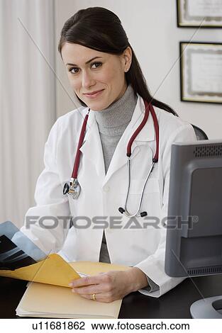 Portrait of female doctor in office View Large Photo Image Stock Image - Portrait of female doctor in office. Fotosearch
