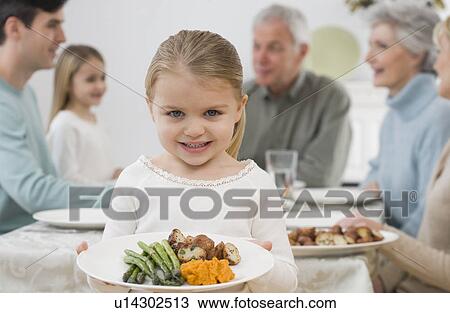Portrait of girl holding plate at Thanksgiving View Large Photo Image Stock Image - Portrait of girl holding plate at Thanksgiving. Fotosearch