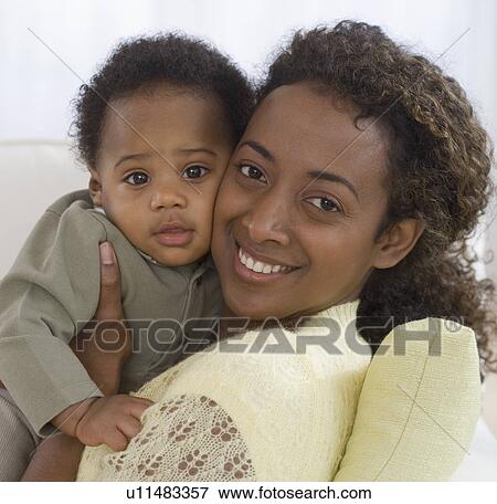 Portrait of mother and baby hugging View Large Photo Image Stock Photo - Portrait of mother and baby hugging. Fotosearch