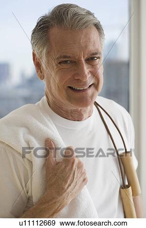 Portrait of senior man holding jump rope over shoulder View Large Photo Image Stock Photo - Portrait of senior man holding jump rope over shoulder. Fotosearch