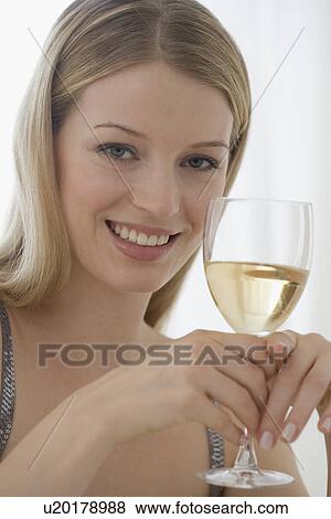 Stock Photo - Portrait of woman holding glass of wine. Fotosearch