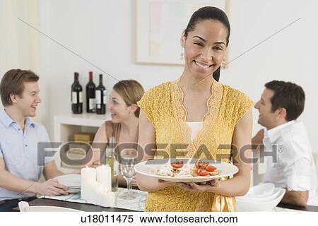 Portrait of woman holding plate of food View Large Photo Image Stock Photography - Portrait of woman holding plate of food. Fotosearch