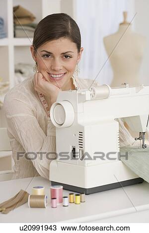 Portrait of woman next to sewing machine View Large Photo Image Stock Image - Portrait of woman next to sewing machine. Fotosearch