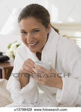 Portrait of woman wearing bathrobe and drinking coffee View Large Photo Image Stock Photo - Portrait of woman wearing bathrobe and drinking coffee. Fotosearch