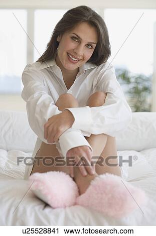 Portrait of woman wearing slippers on bed View Large Photo Image Stock Image - Portrait of woman wearing slippers on bed. Fotosearch