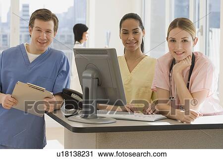 Stock Image - Portrait of young doctors in hospital. Fotosearch