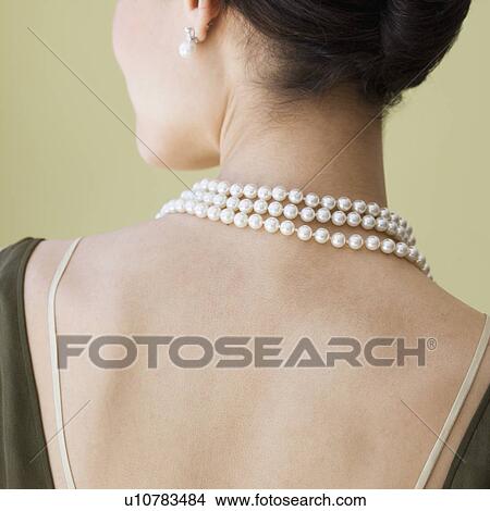 Picture - Rear view of woman wearing pearl necklace. Fotosearch
