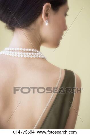 Picture - Rear view of woman wearing pearl necklace. Fotosearch