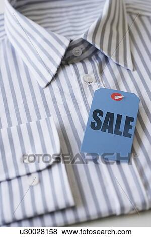 Stock Photo - Sale tag on men’s shirt. Fotosearch