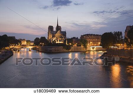 Stock Photo - Scenic view of cathedral next to water at night. Fotosearch