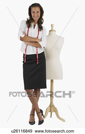 Seamstress standing next to dress dummy View Large Photo Image Stock Photo - Seamstress standing next to dress dummy. Fotosearch
