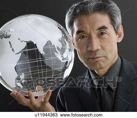 Senior Asian businessman holding clear globe View Large Photo Image Stock Image - Senior Asian businessman holding clear globe. Fotosearch