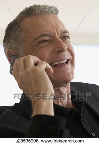 Stock Photograph - Senior businessman talking on cell phone. Fotosearch