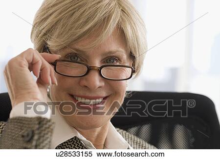 Senior businesswoman wearing eyeglasses View Large Photo Image Stock Photography - Senior businesswoman wearing eyeglasses. Fotosearch