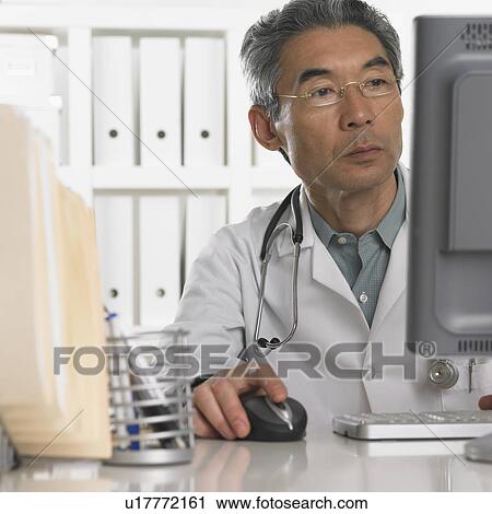 Senior male doctor using computer View Large Photo Image Stock Image - Senior male doctor using computer. Fotosearch