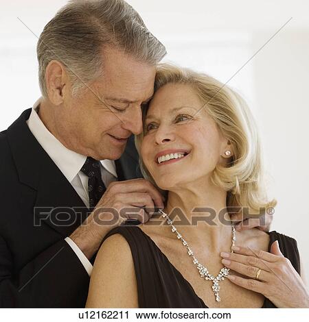 Senior man giving diamond necklace to wife View Large Photo Image Stock Image - Senior man giving diamond necklace to wife. Fotosearch
