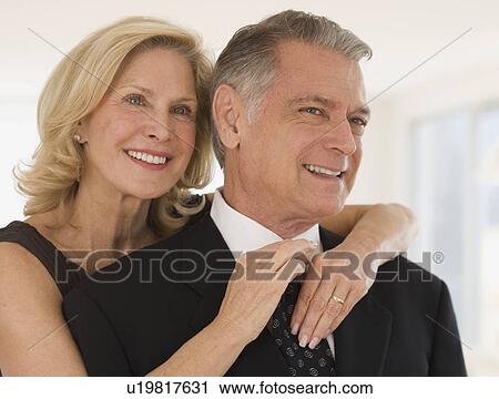Senior woman adjusting husband's necktie View Large Photo Image Stock Image - Senior woman adjusting husband's necktie. Fotosearch