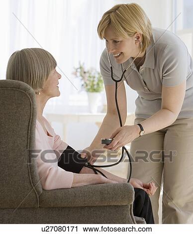Senior woman having blood pressure taken View Large Photo Image Stock Image - Senior woman having blood pressure taken. Fotosearch