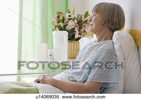 Senior woman laying in hospital bed View Large Photo Image Stock Photography - Senior woman laying in hospital bed. Fotosearch