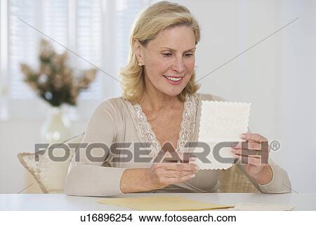 Senior woman reading card View Large Photo Image Picture - Senior woman reading card. Fotosearch