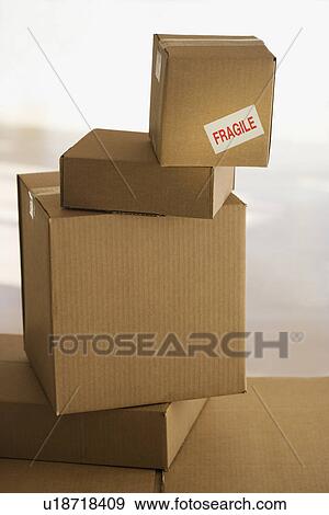Stock Photo - Shipping box with fragile sticker on top of stack. Fotosearch