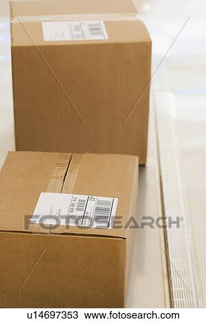 Shipping boxes with labels on conveyor belt View Large Photo Image Stock Image - Shipping boxes with labels on conveyor belt. Fotosearch