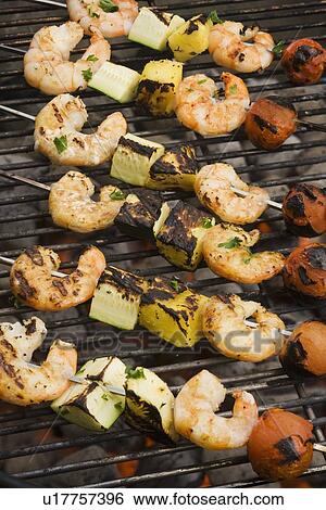 Shish kebab cooking on grill View Large Photo Image Stock Photograph - Shish kebab cooking on grill. Fotosearch