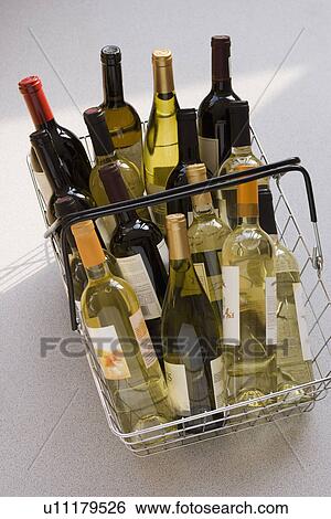 Stock Photograph - Shopping basket filled with wine. Fotosearch