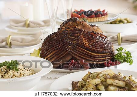 Spiral ham and side dishes on set table View Large Photo Image Stock Image - Spiral ham and side dishes on set table. Fotosearch