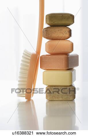 Stock Image - Stack of bar soap and brush. Fotosearch