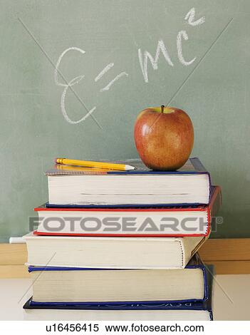 Stack of books and apple in classroom View Large Photo Image Stock Photography - Stack of books and apple in classroom. Fotosearch