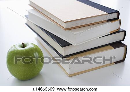 Stack of books and apple View Large Photo Image Stock Photo - Stack of books and apple. Fotosearch