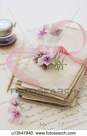 Stack of old letters next to flowers and ink bottle View Large Photo Image Stock Image - Stack of old letters next to flowers and ink bottle. Fotosearch