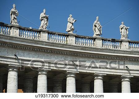 Stock Image - Statues on colonnade at St. Peter’s Basilica, Italy. Fotosearch
