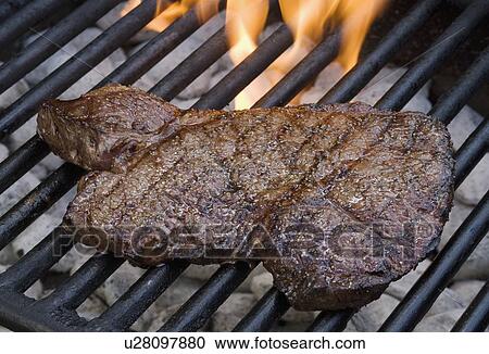 Steak cooking on grill View Large Photo Image Stock Image - Steak cooking on grill. Fotosearch