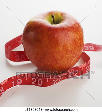 Studio shot of apple and tape measure View Large Photo Image Stock Image - Studio shot of apple and tape measure. Fotosearch