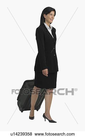 Studio shot of businesswoman pulling suitcase View Large Photo Image Stock Photo - Studio shot of businesswoman pulling suitcase. Fotosearch