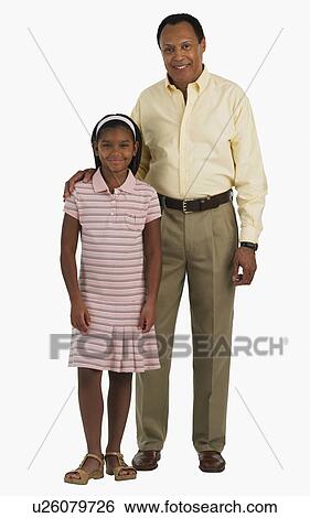 Studio shot of father with arm around daughter View Large Photo Image Stock Photograph - Studio shot of father with arm around daughter. Fotosearch