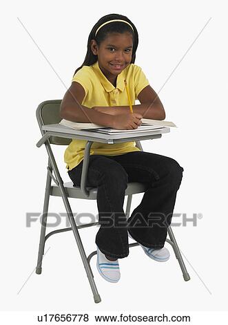 Studio shot of girl doing school work View Large Photo Image Stock Photo - Studio shot of girl doing school work. Fotosearch