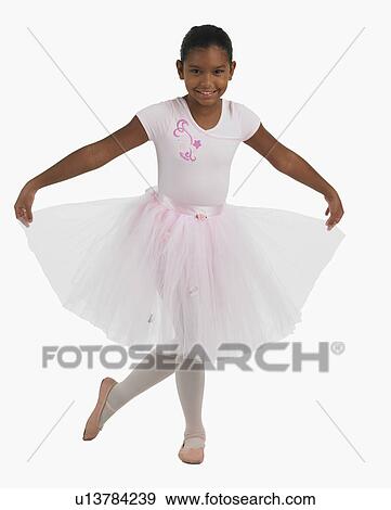Stock Photo - Studio shot of girl practicing ballet. Fotosearch