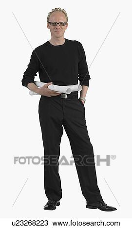 Stock Image - Studio shot of man holding blueprints. Fotosearch