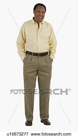 Stock Photo - Studio shot of man with hands in pockets. Fotosearch