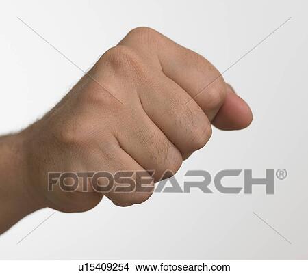 Picture - Studio shot of man's hand making fist. Fotosearch