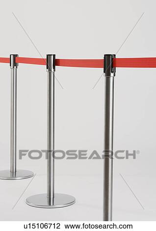 Stock Image - Studio shot of retractable belt crowd control barriers. Fotosearch