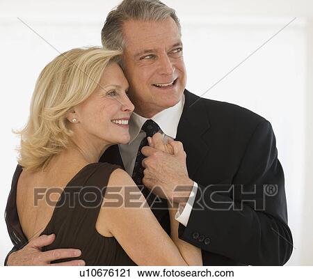 Stock Image - Studio shot of senior couple dancing. Fotosearch