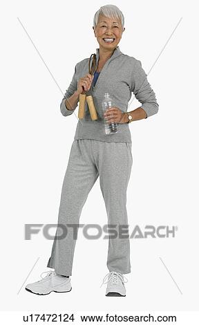 Studio shot of senior woman wearing athletic gear View Large Photo Image Picture - Studio shot of senior woman wearing athletic gear. Fotosearch